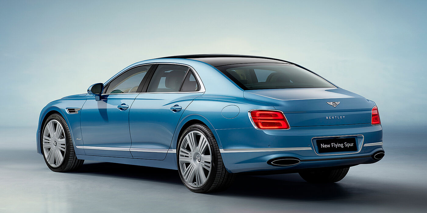 Bentley Padova New Bentley Flying Spur Azure sedan rear view in Light windsor blue by Mulliner paint with 22 inch Azure wheels and chrome exterior details