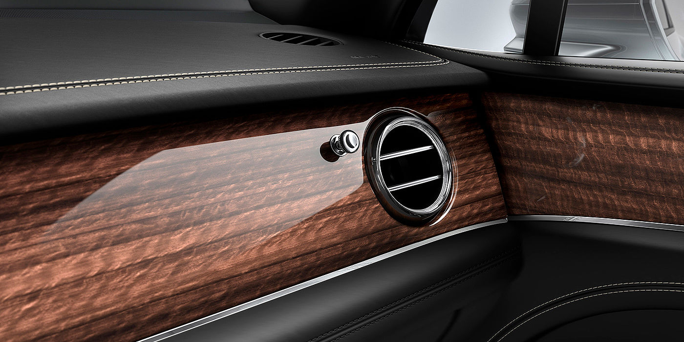 Bentley Padova Bentley Bentayga front interior Crown Cut Walnut veneer and chrome air vent.
