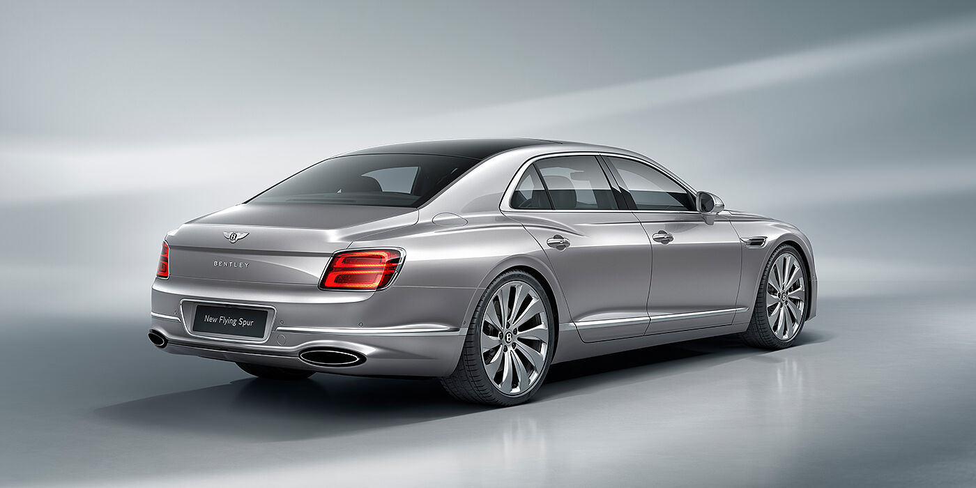 Bentley Padova New Bentley Flying Spur sedan rear view in Silverlake paint with ten spoke wheels and chrome matrix grille