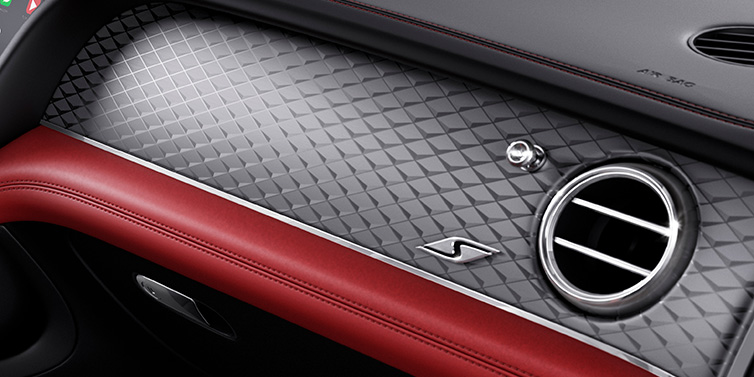 Bentley Padova Bentley Bentayga S SUV front interior dash with Dark Tint Diamond Brushed Aluminium veneer and S badge surrounded by Hotspur red and Beluga black hide