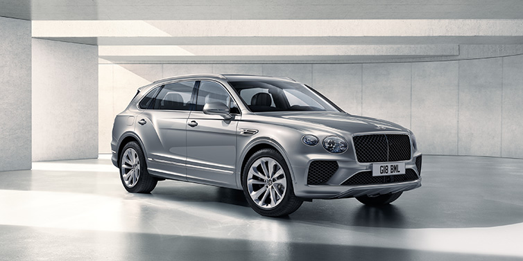 Bentley Padova Bentley Bentayga Extended Wheelbase SUV front three quarter in Moonbeam paint with a grey background