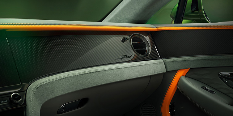 Bentley Padova Bentley Continental GT Speed coupe front interior dash detail with high gloss carbon fibre veneer surrounded by Mandarin by Mulliner and Gravity Grey hides