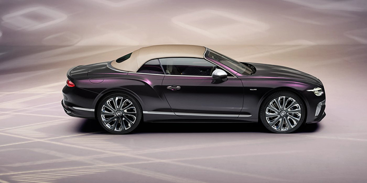 Bentley Padova Bentley Continental GTC Mulliner convertible in profile with hood up, in Tanzanite Purple paint and 22 inch Mulliner painted and polished wheels