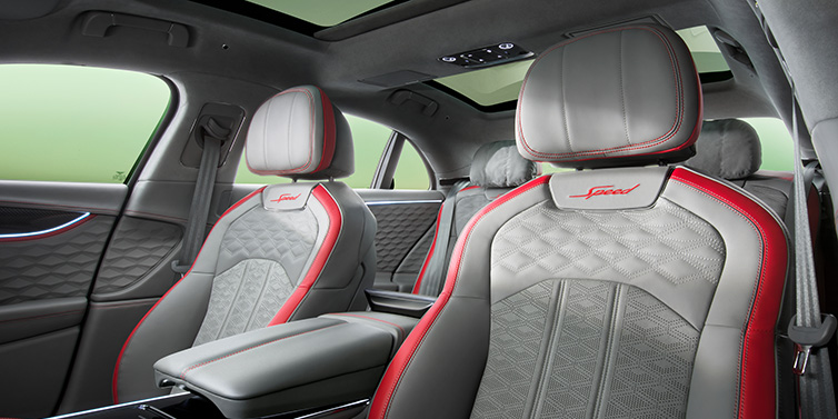 Bentley Padova Bentley Flying Spur Speed sedan interior showing front and rear seats in Hotspur red and Gravity Grey hides, with Speed seat emblems