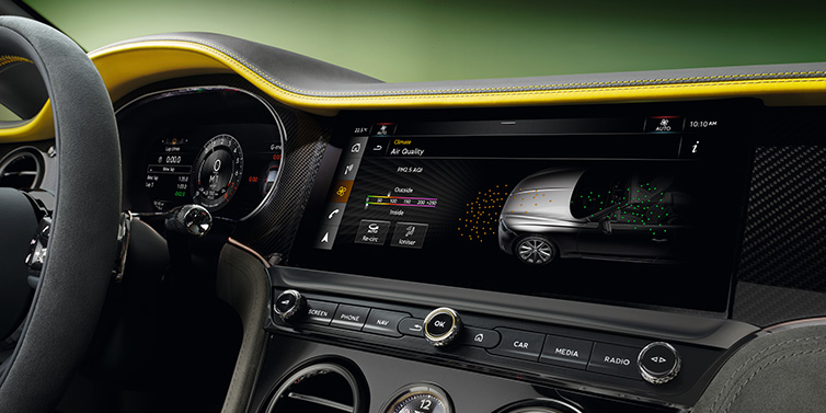 Bentley Padova Bentley Continental GTC Speed convertible front interior centre console with MMI screen showing Air Quality visualisation surrounded by Cyber Yellow by Mulliner and Gravity Grey hides and high gloss carbon fibre veneer