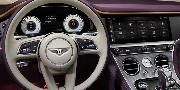 Bentley Padova Bentley Continental GTC Mulliner convertible steering wheel and drivers screens surrounded by Damson purple and Linen hides